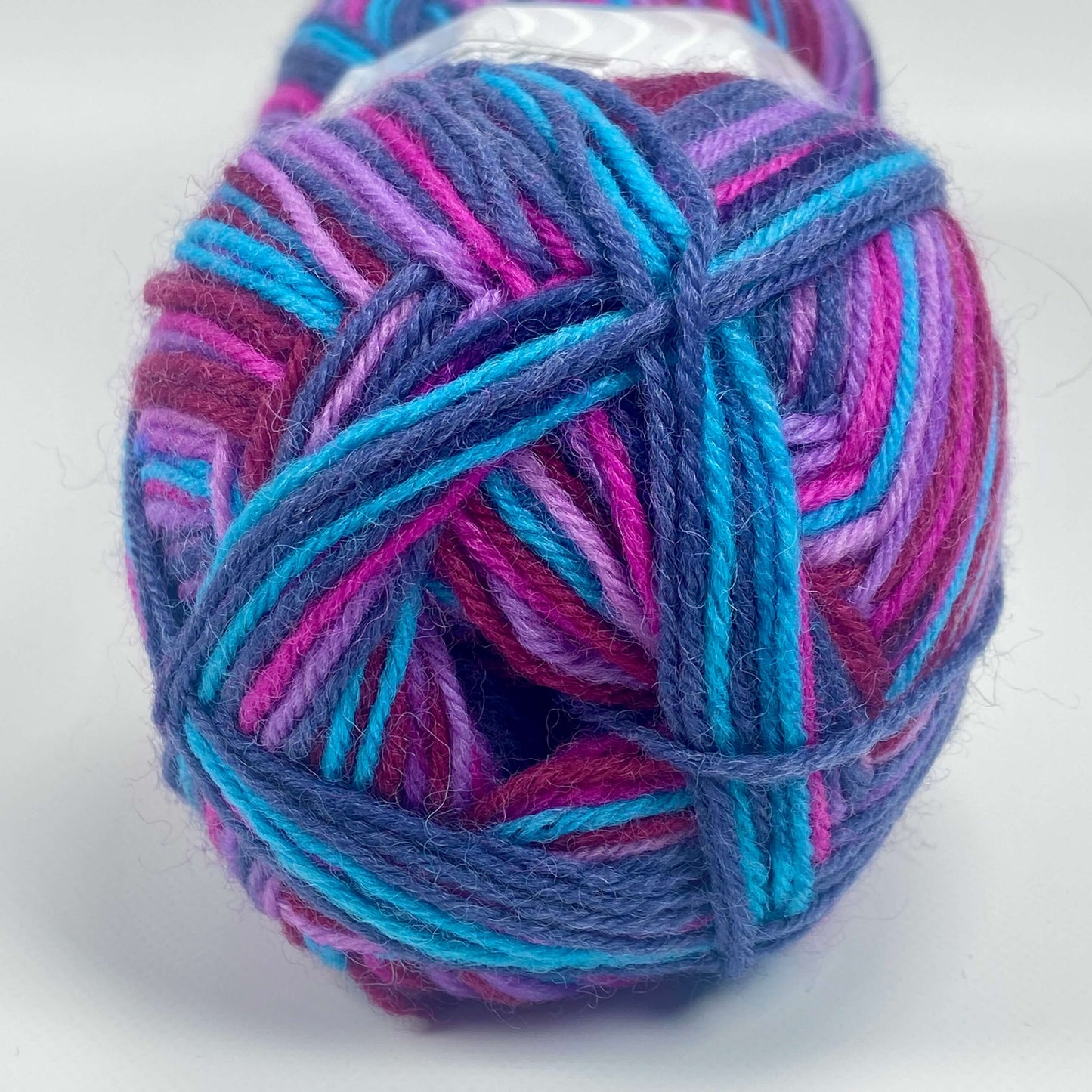 ball of sock yarn in purple, maroon, turquoise and fuchsia - The Sock Knittery