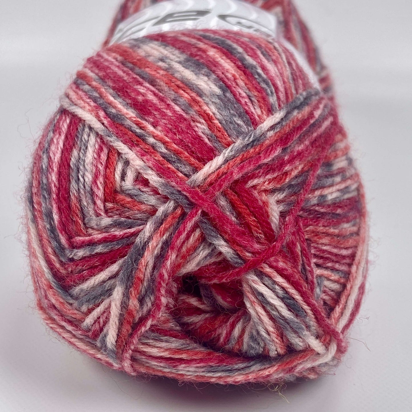 ball of sock yarn by Ice Yarn in red, orange, grey and cream - The Sock Knittery