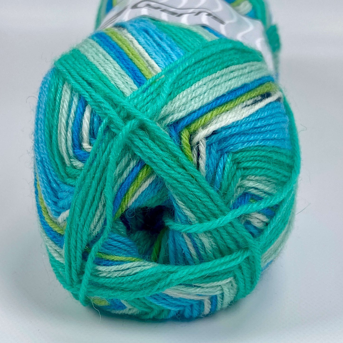 ball of sock yarn by Ice Yarns in colors turquoise, black, green shades - The Sock Knittery