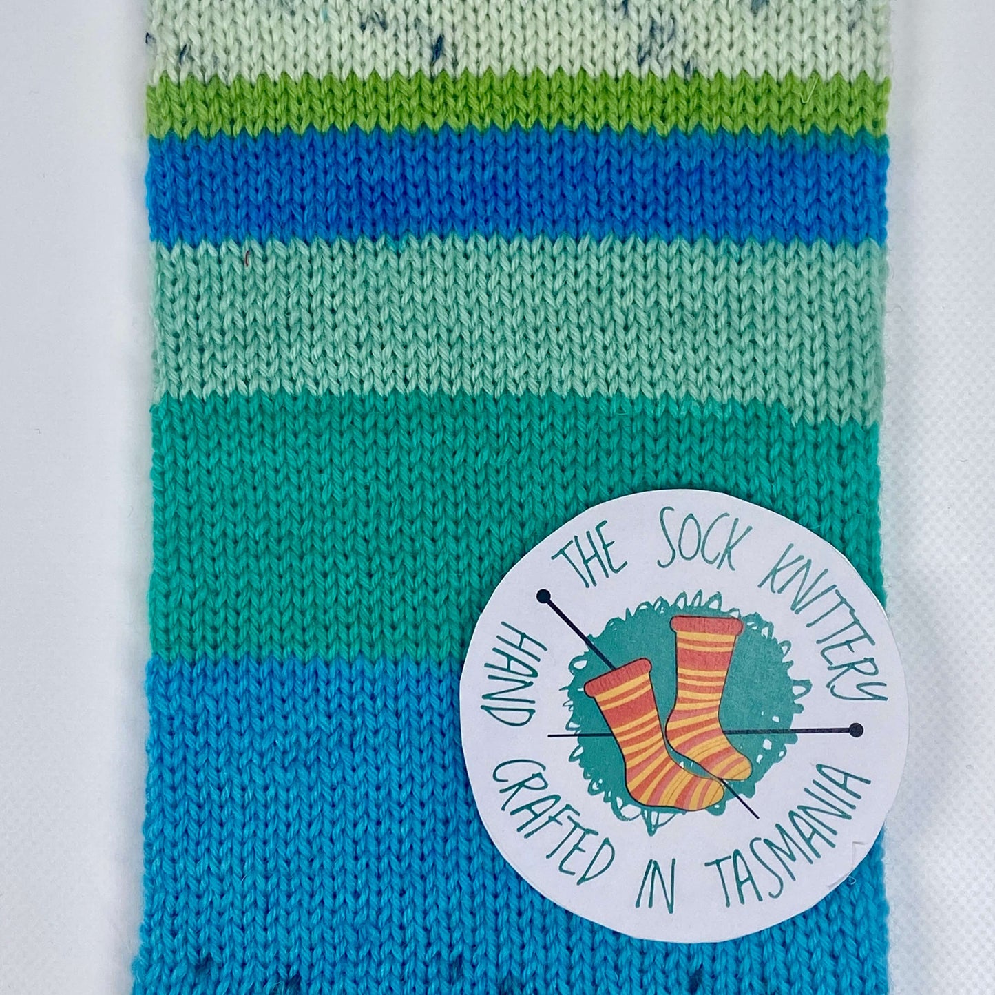 sample of striped Ice Yarns sock yarn in turquoise, black, green shades - The Sock Knittery