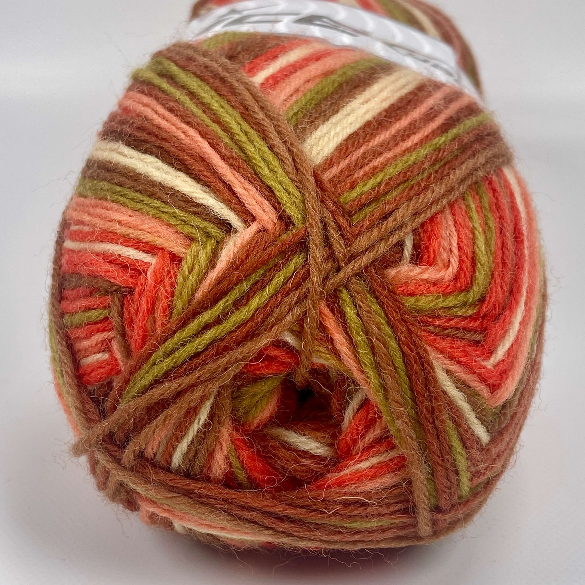 Ball of sock yarn by Ice Yarns in brown, orange, green and salmon - The Sock Knittery